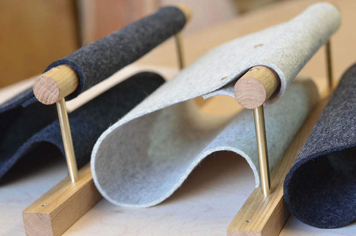 oak, brass and felt magazine racks in production