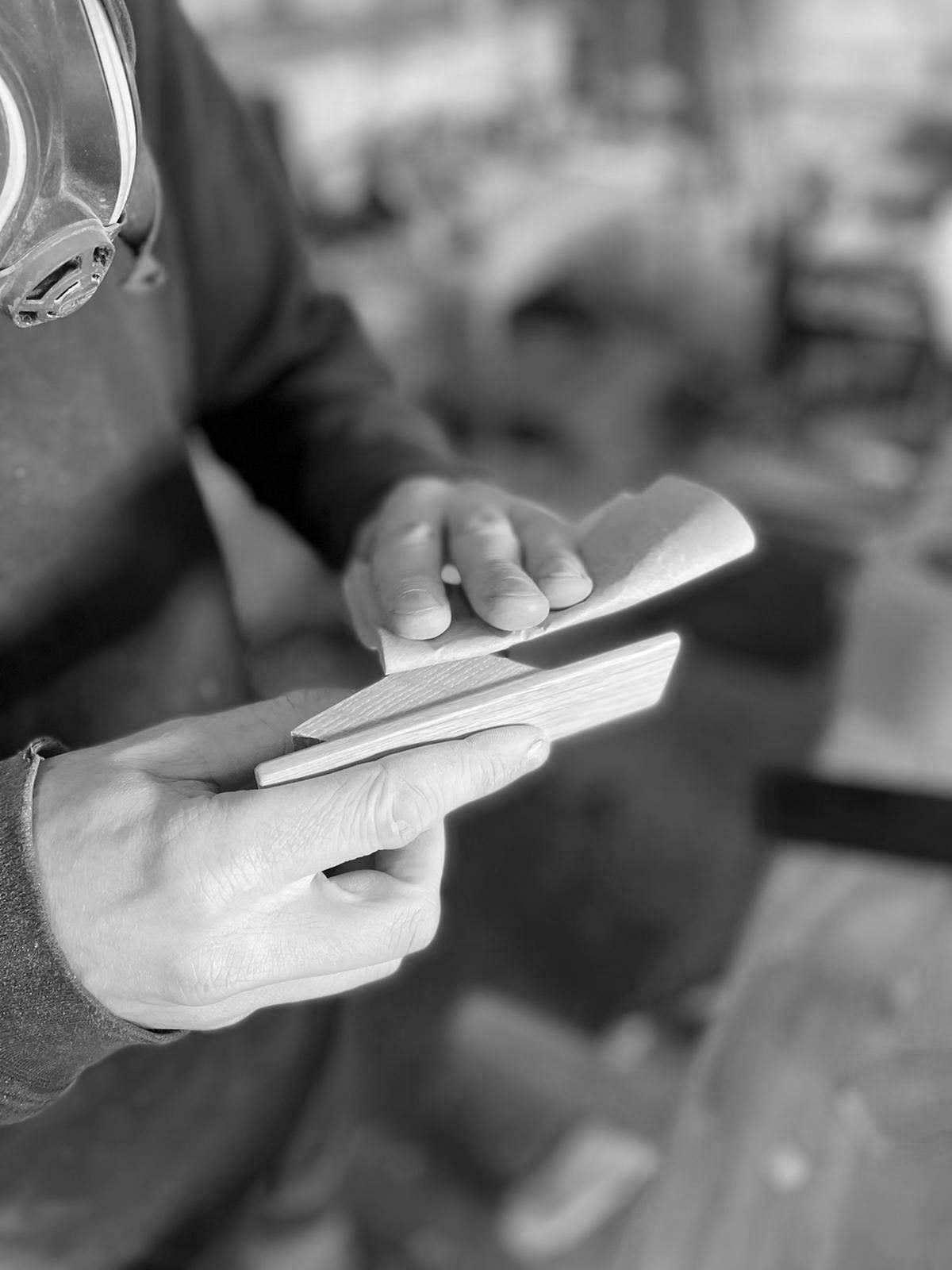 hand sanding a wooden coat hook