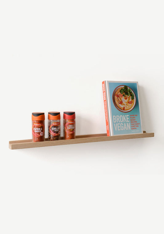 narrow oak shelf with herbs and spices and book