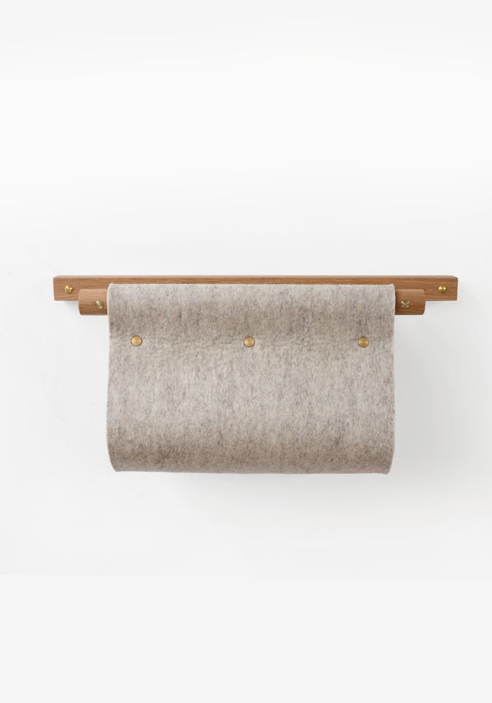 Wall mounted magazine rack and mail holder made from oak, brass and grey felt.