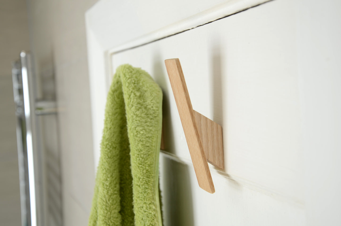 simple wooden wall hook made from ash in a bathroom with towel