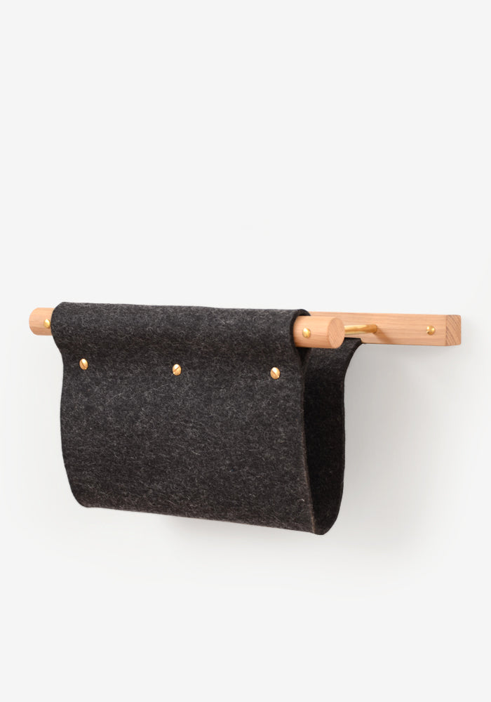 Wall mounted magazine rack and mail holder made from oak, brass and black felt.