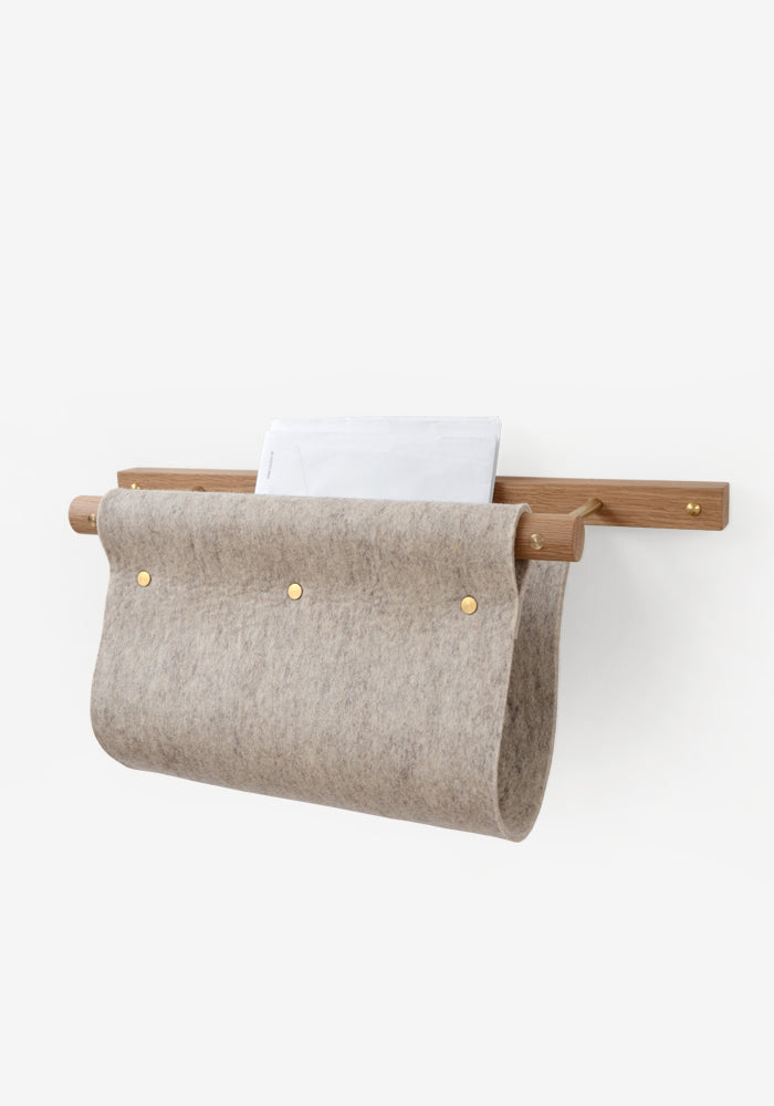 Wall mounted magazine rack and mail holder made from oak, brass and grey felt.